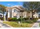 Inviting condo exterior featuring a lush lawn, mature trees, and convenient stair access at 10100 Jacob Pl # 204, Las Vegas, NV 89144