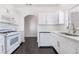 This kitchen features a gas range, white cabinets, counters, and a stainless steel sink at 10100 Jacob Pl # 204, Las Vegas, NV 89144