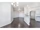 Open-concept living space with hardwood floors, chandelier lighting and arched doorways at 10100 Jacob Pl # 204, Las Vegas, NV 89144