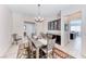 Elegant dining room with modern chandelier, wood table and chairs, and built-in buffet at 1012 Terron Allen Ave, North Las Vegas, NV 89031