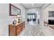 The entryway is well-lit, showcasing light floors, tasteful decor, and a view leading to the living area at 1012 Terron Allen Ave, North Las Vegas, NV 89031