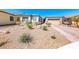 Inviting home boasting desert landscaping, a brick driveway, and a well-maintained exterior under a clear blue sky at 1012 Terron Allen Ave, North Las Vegas, NV 89031