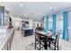 Open concept kitchen with island, stainless appliances, dining area, and sliding doors to the backyard at 1012 Terron Allen Ave, North Las Vegas, NV 89031