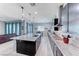 Bright kitchen features a large island, granite countertops, stainless steel appliances, and adjacent living space at 1012 Terron Allen Ave, North Las Vegas, NV 89031