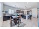 Modern kitchen featuring a large island, granite countertops, stainless steel appliances, and a breakfast nook at 1012 Terron Allen Ave, North Las Vegas, NV 89031