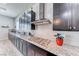 Modern kitchen with granite countertops, stainless steel appliances, and herringbone tile backsplash at 1012 Terron Allen Ave, North Las Vegas, NV 89031