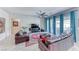 Comfortable living room with a ceiling fan, view of outdoor patio, neutral paint, and tile floors at 1012 Terron Allen Ave, North Las Vegas, NV 89031