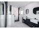 Modern bathroom features a double sink vanity and glass enclosed shower with black and white tiling at 1088 Casady Hollow Ave, Henderson, NV 89012