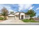 Inviting single-story home featuring a three-car garage and well-manicured front lawn and landscape at 1088 Casady Hollow Ave, Henderson, NV 89012