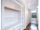 Hallway view with built in shelving and access to a bathroom with a shower/tub combo at 1088 Casady Hollow Ave, Henderson, NV 89012