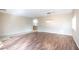 Open living space with rich wood flooring and contemporary light fixtures at 1088 Casady Hollow Ave, Henderson, NV 89012