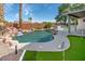 Backyard pool features a waterfall, built-in barbecue, and putting green for outdoor entertaining at 1088 Casady Hollow Ave, Henderson, NV 89012
