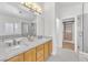 Modern bathroom with double sinks, marble countertops, separate shower and walk-in closet at 10955 Sospel Pl, Las Vegas, NV 89141