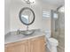 Bathroom vanity and silver sink, paired with a large round mirror and glass-enclosed shower at 10955 Sospel Pl, Las Vegas, NV 89141