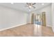 Bright bedroom with hardwood floors, a ceiling fan and sliding glass doors at 10955 Sospel Pl, Las Vegas, NV 89141