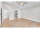 Spacious bedroom with ceiling fan, hardwood floors and view of the ensuite bathroom at 10955 Sospel Pl, Las Vegas, NV 89141
