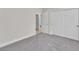Clean bedroom with gray carpet, showing a view of the closets and hallway at 10955 Sospel Pl, Las Vegas, NV 89141
