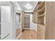 Walk in closet with hardwood floors and lots of shelves, drawers and rod space at 10955 Sospel Pl, Las Vegas, NV 89141