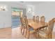 Dining room features hardwood floors, neutral walls, and sliding glass door to backyard at 10955 Sospel Pl, Las Vegas, NV 89141