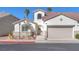 Charming single-story home with a well-manicured lawn, mature trees, and an attached garage at 10955 Sospel Pl, Las Vegas, NV 89141
