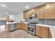 Well-equipped kitchen with stainless steel appliances, ample counter space, and wood cabinetry at 10955 Sospel Pl, Las Vegas, NV 89141