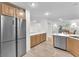 Functional kitchen with stainless steel appliances, long counter tops, and wood cabinetry at 10955 Sospel Pl, Las Vegas, NV 89141