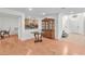 Open concept living room with hardwood floors, natural light and classic china cabinet at 10955 Sospel Pl, Las Vegas, NV 89141