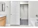 View of the walk-in closet with neutral carpet through a sliding door in the bathroom at 10955 Sospel Pl, Las Vegas, NV 89141