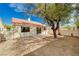 Backyard features a brick patio, mature tree, stucco wall, and access to the interior via a sliding glass door at 1645 Indian Cove Ln, Las Vegas, NV 89128