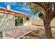 Backyard features a brick patio, mature tree, stucco wall, and access to the interior via a sliding glass door at 1645 Indian Cove Ln, Las Vegas, NV 89128