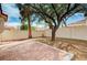 Backyard features a brick patio, mature trees, and a block wall at 1645 Indian Cove Ln, Las Vegas, NV 89128