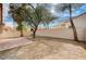 Backyard features a brick patio, mature trees, and a block wall at 1645 Indian Cove Ln, Las Vegas, NV 89128