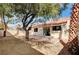 Private backyard featuring a mature tree, patio area and block wall at 1645 Indian Cove Ln, Las Vegas, NV 89128