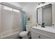 Cozy bathroom features a tiled shower-tub, sleek vanity, and a framed mirror at 1645 Indian Cove Ln, Las Vegas, NV 89128