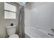 Bathroom featuring a modern shower-tub and toilet with a navy accent at 1645 Indian Cove Ln, Las Vegas, NV 89128