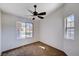 This bedroom has a large window, a ceiling fan, plush carpeting, and plenty of natural light at 1645 Indian Cove Ln, Las Vegas, NV 89128