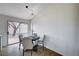 Cozy dining area with gray chairs, a round table, and a sliding door to the backyard at 1645 Indian Cove Ln, Las Vegas, NV 89128