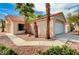Single-story home with a well-maintained lawn, complemented by mature palm trees and desert landscaping at 1645 Indian Cove Ln, Las Vegas, NV 89128
