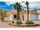 Charming single-story home with a well-manicured yard, beautiful palm trees, and a tile roof at 1645 Indian Cove Ln, Las Vegas, NV 89128