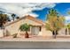 Charming single-story home with a white front door, well-kept yard, and mature palm trees at 1645 Indian Cove Ln, Las Vegas, NV 89128