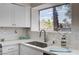 Kitchen sink and counter feature neutral tiling at 1645 Indian Cove Ln, Las Vegas, NV 89128