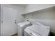 Laundry room with side by side washer and dryer, and a utility shelf at 1645 Indian Cove Ln, Las Vegas, NV 89128