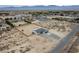 This aerial view captures a home with a large, fenced-in yard, desert landscaping, and mountain views at 1660 W Princeton Cir, Pahrump, NV 89060