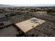 An aerial view of a home with a large, fenced-in lot featuring desert landscaping and mountain views at 1660 W Princeton Cir, Pahrump, NV 89060