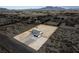 Aerial view of a newly constructed home with a large backyard, surrounded by desert landscape at 1660 W Princeton Cir, Pahrump, NV 89060