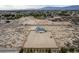 An aerial view shows a home with a large, fenced-in yard, a play structure, and desert landscaping at 1660 W Princeton Cir, Pahrump, NV 89060
