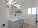 Bright bathroom featuring a vessel sink, grey vanity, modern fixtures, and a window at 1660 W Princeton Cir, Pahrump, NV 89060