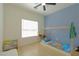 Stylized bedroom with blue accent wall, unique bed frame, and ample natural light at 1660 W Princeton Cir, Pahrump, NV 89060