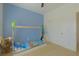 Modern bedroom with blue accent wall, unique bed frame, and neutral flooring at 1660 W Princeton Cir, Pahrump, NV 89060