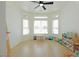 Bright bedroom featuring a bay window, ceiling fan, and wood-look flooring at 1660 W Princeton Cir, Pahrump, NV 89060